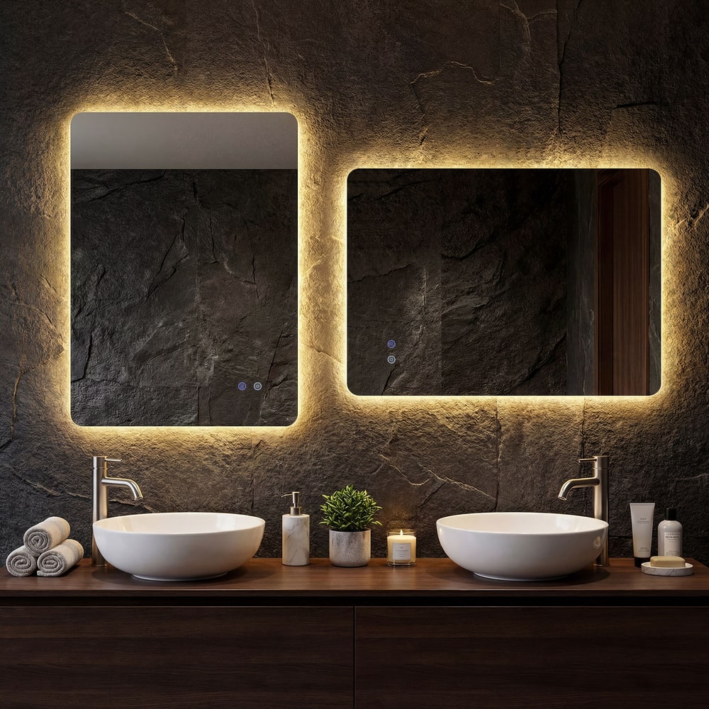 Two illuminated mirrors are mounted side by side above sinks in a modern bathroom vanity