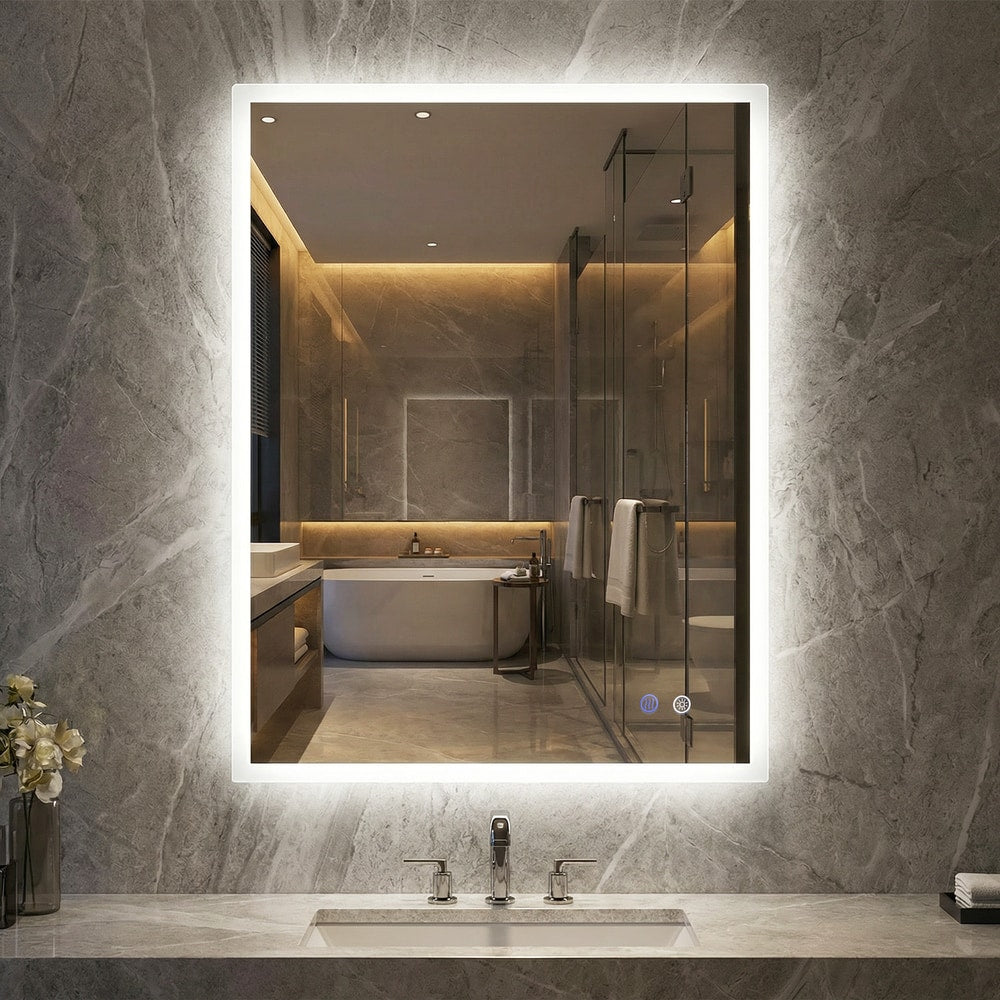 The bathroom mirror with bright white LED lighting mounted on a grey marble wall