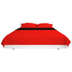 The quilted bedspread in red draped over a bed with a black accent strip