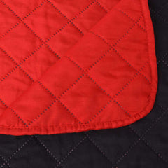 A close up of the quilted fabric showing the diamond stitching pattern and rounded corner