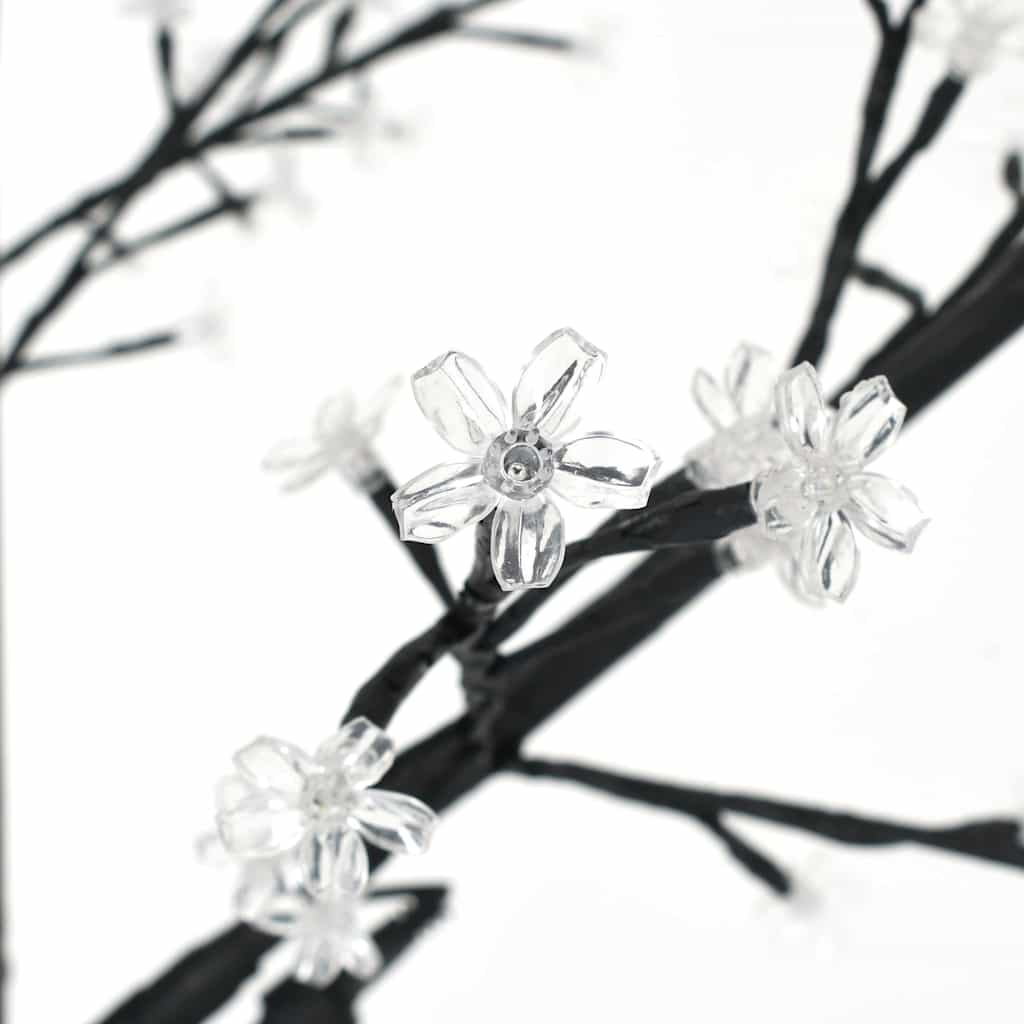 Close-up of the clear cherry blossom flowers on the branches of the Christmas tree