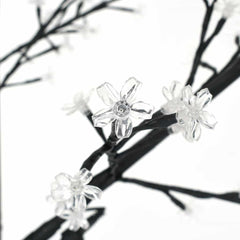 Close-up of the clear cherry blossom flowers on the branches of the Christmas tree