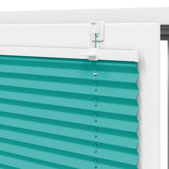 Close-up of the top fitting of the petrol green pleated blind