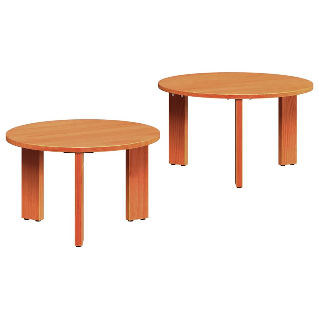 Two round wooden coffee tables with four legs each, in a light wood finish