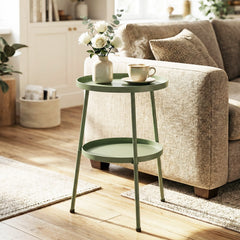 The two-tier round coffee end table in a living room next to a sofa