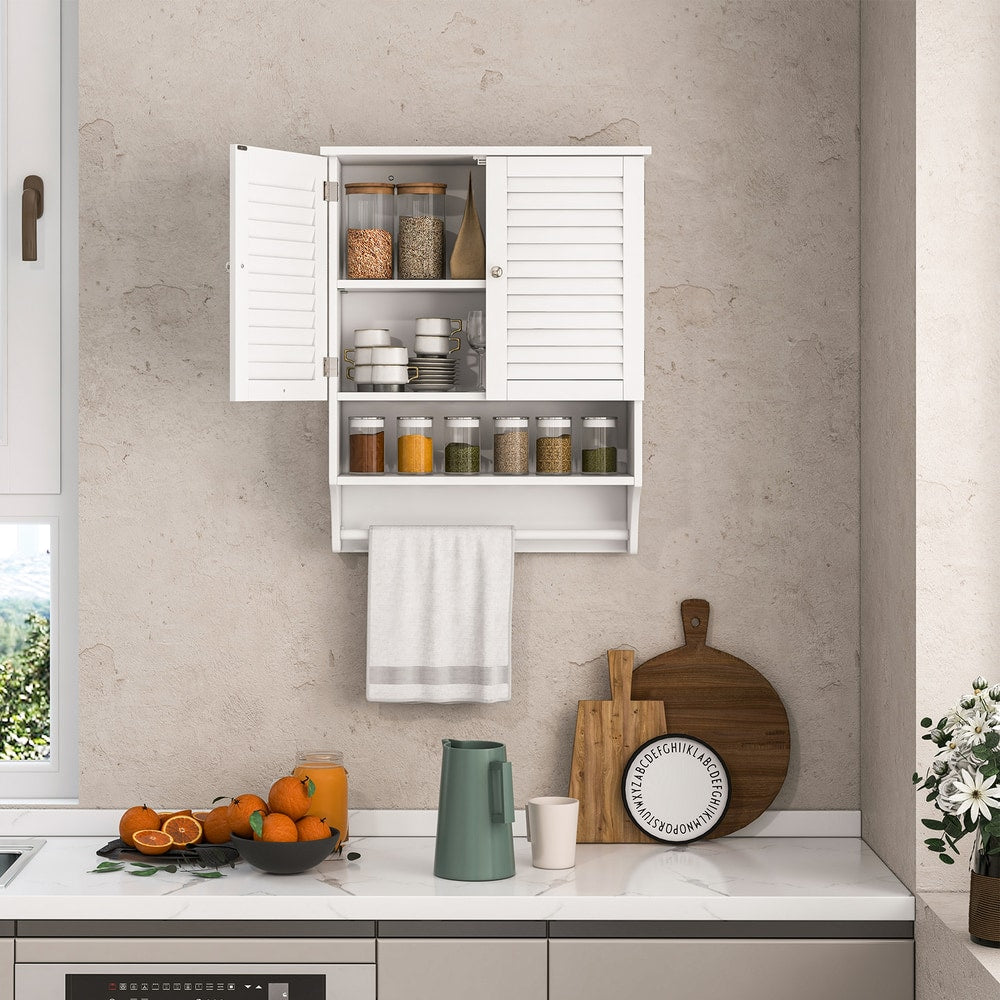 The cabinet is mounted in a kitchen, holding jars and a towel on the rail