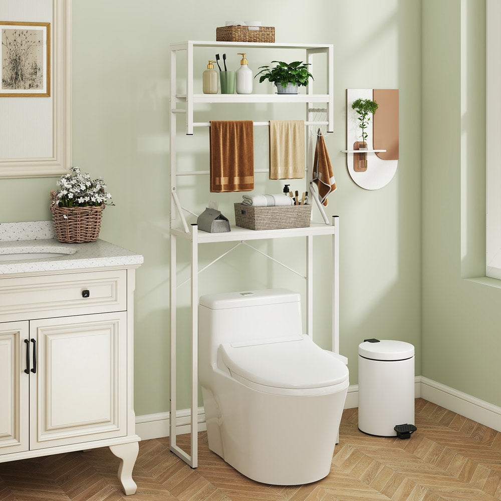 The bathroom storage unit placed over a toilet in a light green room with a vanity unit