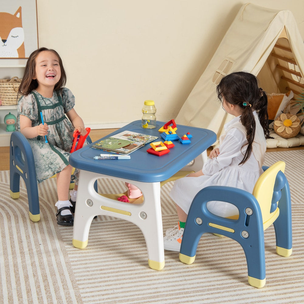 The kids table and chair set being used by two children playing in a bright playroom