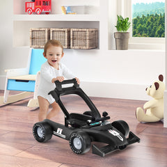 Baby push walker in black, with a baby standing behind it
