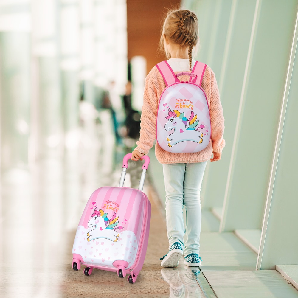 The kids luggage being pulled by a young girl walking through an airport terminal