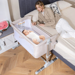 The bedside sleeper positioned next to a double bed with a baby lying inside