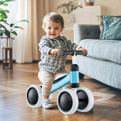 A smiling baby sits on the blue balance bike inside a living room