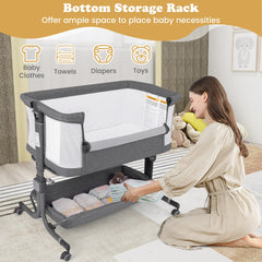 The grey bassinet bedside sleeper with a woman placing items into the bottom storage rack