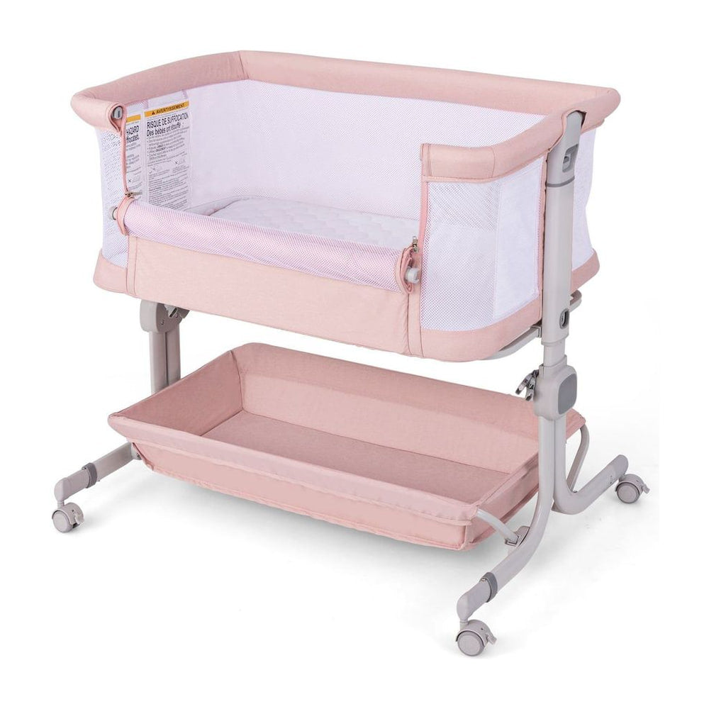 Baby Bassinet Bedside Sleeper in pink with a storage shelf underneath and adjustable legs