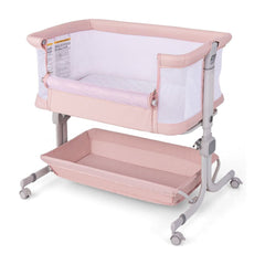 Baby Bassinet Bedside Sleeper in pink with a storage shelf underneath and adjustable legs
