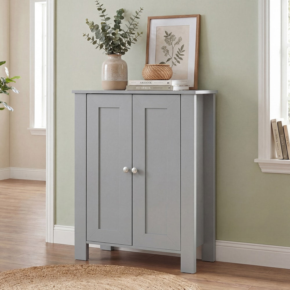 The grey wooden storage cabinet in a hallway with a rug and a picture on the wall
