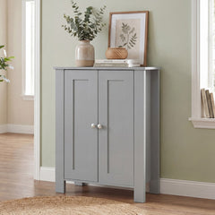 The grey wooden storage cabinet in a hallway with a rug and a picture on the wall