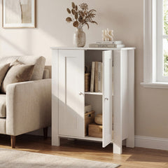 Freestanding white cabinet with double doors open, styled in a living room with books and decorative items