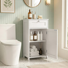 The floor cabinet with the door open showing towels and bottles on the shelf
