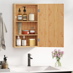 The wooden wall cabinet hanging above a bathroom sink with the door open to reveal items