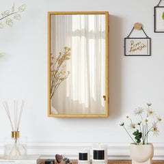 The wall cabinet mounted on a white wall with a closed mirror door reflecting the room