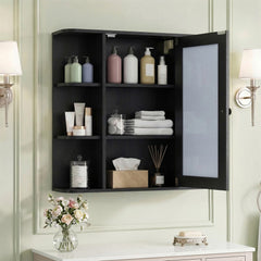 The black wall cabinet with mirror with its door open, revealing three internal shelves with toiletries