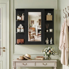 The black wall cabinet with mirror mounted on a wall in a hallway, styled with hats and a vase