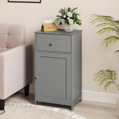 The floor cabinet placed in a living room next to a sofa with a flower vase on top