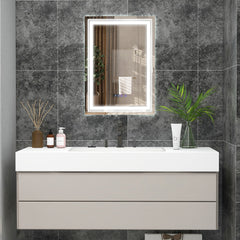 The LED vanity mirror with illuminated border above a bathroom sink and vanity unit