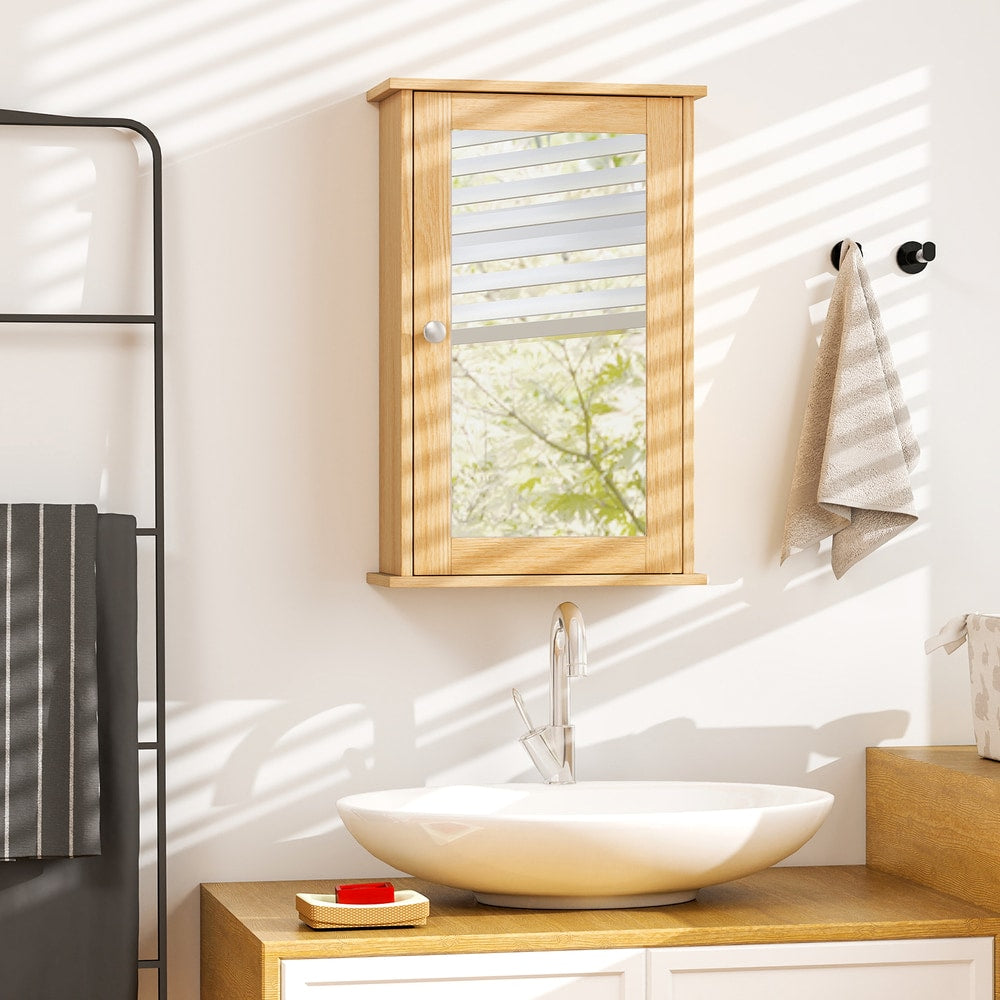 Wall cabinet with mirror in a bright bathroom with a sink and towels