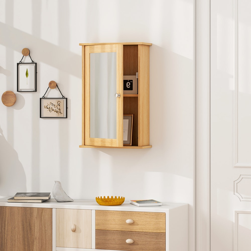 The wall cabinet with mirror mounted on a wall above a dresser