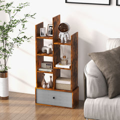 Rustic brown wooden bookshelf with a grey fabric drawer, styled in a living room setting
