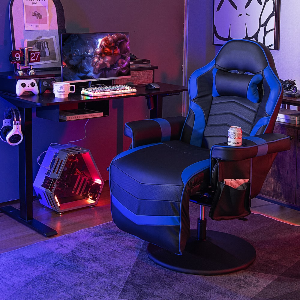 The gaming chair placed in a dark room next to a computer desk with gaming equipment