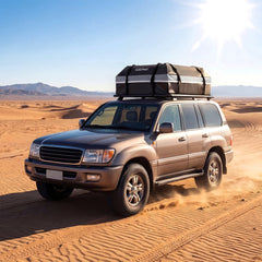 The grey roof bag on a car driving on sand dunes