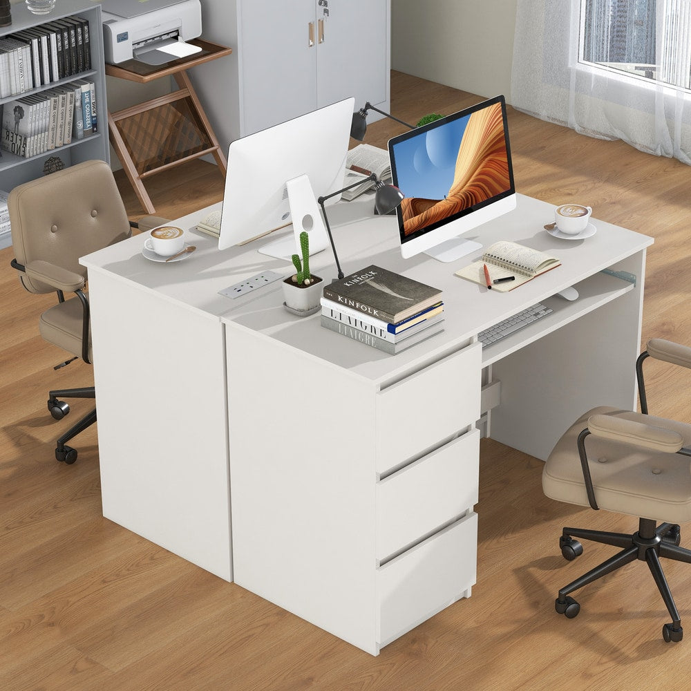 Two white computer desks with drawers and keyboard trays placed side-by-side in a modern office space