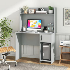The office desk positioned in a bright home study with a chair and computer equipment