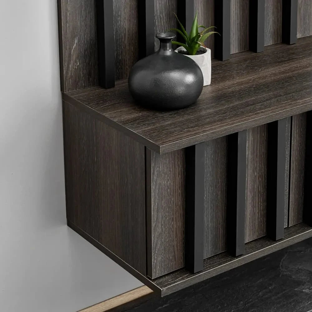 The entertainment unit is mounted to the wall with a dark wood finish and a decorative vase on top
