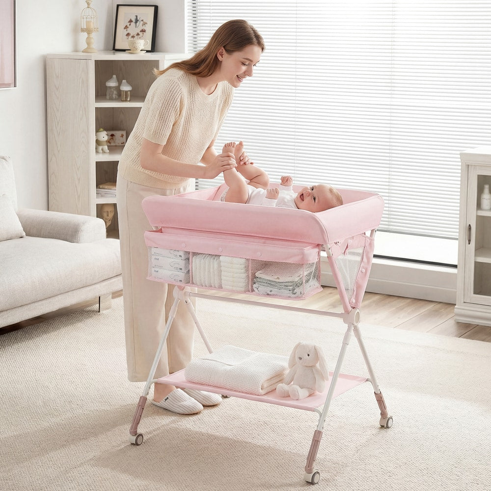 Pink changing table in use with a mother changing her baby's nappy