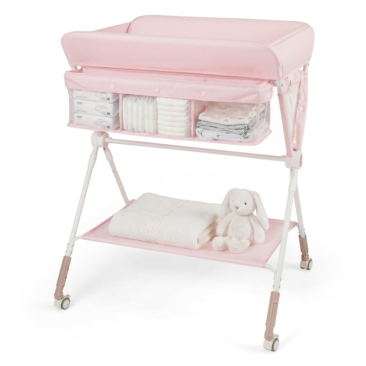 Pink changing table with storage pockets full of nappies and a folded towel