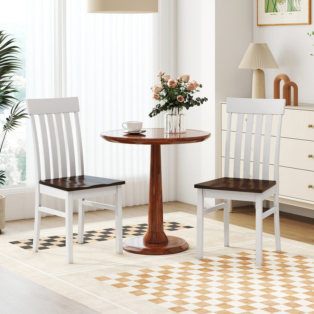 The dining chairs placed on either side of a small pedestal table