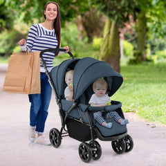 The blue double pushchair with two children seated inside on a park path