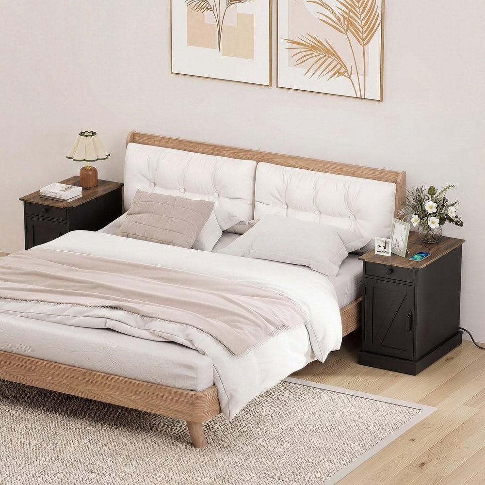 Two black bedside tables either side of a bed in a bedroom