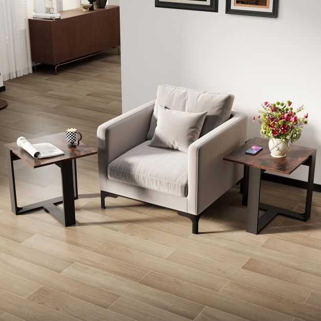 Two rustic brown end tables in a living room setting