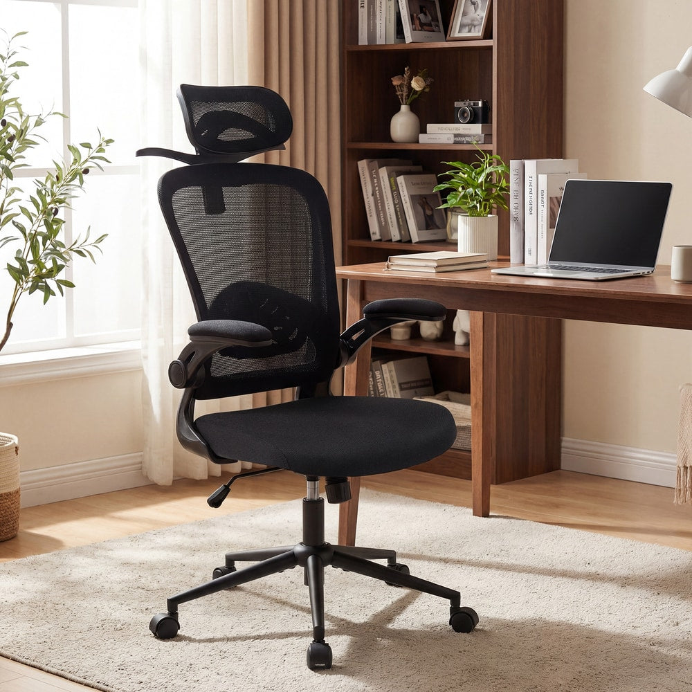 The office chair placed next to a wooden desk with a laptop and books
