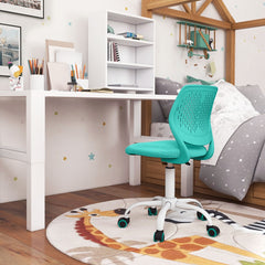 The kids chair tucked under a white desk in a bedroom with a wooden bed frame and animal print rug