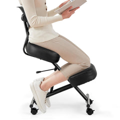 A person sitting on the posture correction stool, demonstrating its use