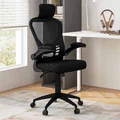 The office chair placed in a bright home study next to a white desk and wooden shelving unit