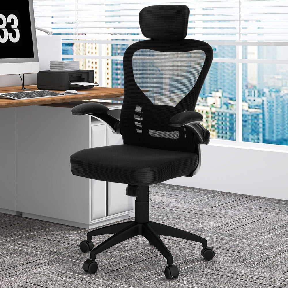 The office chair positioned in a professional workspace with a large window and city view