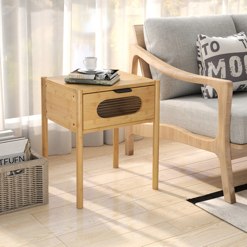 A single farmhouse bedside table nightstand next to a sofa