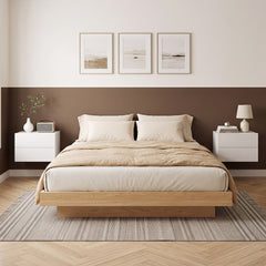 Two white floating bedside tables mounted on a wall either side of a bed